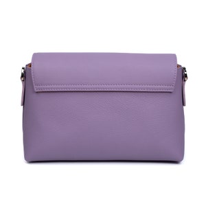 PEGAI Helen Lilac Pebbled Calfskin Leather Handbag featuring a sleek crossbody design, adjustable metal and leather strap, nickel-plated hardware, and a secure magnetic closure. Perfect for a luxurious and stylish look.