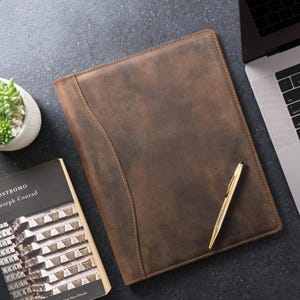 A Marshall Chestnut leather folio resting on a slate desk—handcrafted for your next big idea, with space for pen, notes, and story.