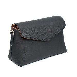 PEGAI Helen Black Pebbled Calfskin Leather Handbag featuring a sleek crossbody design, adjustable metal and leather strap, gold-plated hardware, and a secure magnetic closure. Perfect for a luxurious and stylish look.