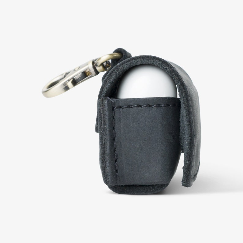Side view of Charcoal leather case with AirPods inside—soft suede interior and sleek fit for wireless charging on the go.