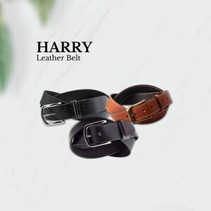May include: Three leather belts in black, brown, and dark brown, each with a silver or gold-coloured buckle. The belts are arranged in a circular pattern. The text "HARRY Leather Belt" is at the top.
