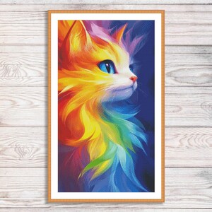 May include: A framed artwork featuring a colorful cat portrait. The cat's fur transitions through a rainbow of hues, from orange and yellow to green and blue. It has bright blue eyes and a white face, set against a dark blue background.