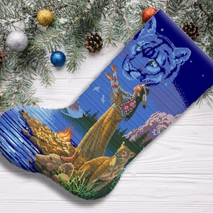 May include: A blue and white Christmas stocking featuring a Native American woman and a cougar design. The stocking is decorated with stars and a campfire.