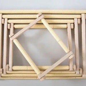 May include: A set of wooden embroidery hoops, nested together, with a light brown finish. The hoops are made of natural wood and have a smooth, polished surface.