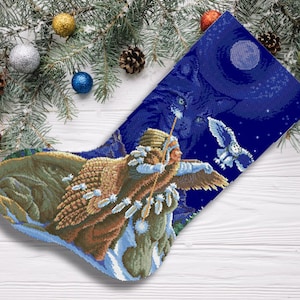 May include: A blue Christmas stocking with a detailed embroidered design of a Native American woman holding a bow and arrow, with owls flying in the night sky.