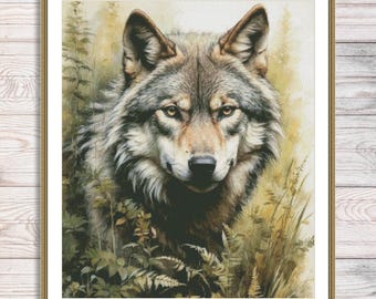 May include: A framed cross-stitch of a wolf's head, featuring detailed fur in shades of gray, brown, and white. The wolf's yellow eyes are focused forward. The background includes green foliage and tall grass, with a wooden frame.
