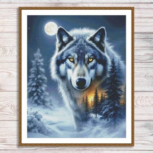 May include: Framed artwork featuring a detailed portrait of a wolf with piercing yellow eyes. The wolf is set against a snowy forest scene with a full moon in the background. The artwork is in a wooden frame.