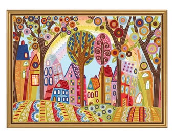 May include: A framed, colorful cross-stitch artwork depicting a whimsical town scene. The artwork features vibrant houses, trees with decorative foliage, and a rainbow in the sky. The color palette includes blues, reds, yellows, and greens.