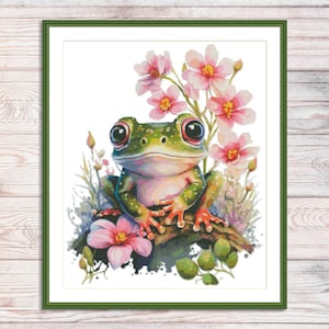 May include: A green frog with large, black eyes sits on a branch with pink flowers. The frog has a white belly and orange spots on its legs.