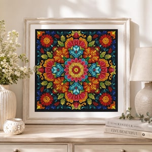 May include: A square framed wall art piece featuring a vibrant, symmetrical floral mandala pattern on a black background. The design incorporates intricate layers of red, orange, yellow, pink, and turquoise petals and leaves arranged in a repeating radial motif.