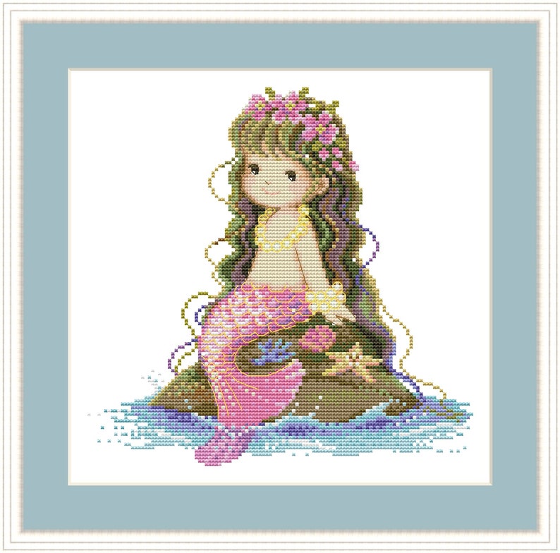 May include: A cross-stitch pattern of a mermaid with long green hair, a pink tail, and a flower crown. She is sitting on a rock with a starfish beside her.
