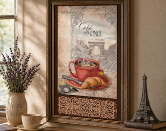 Puede incluir: Una lámina de arte enmarcada titulada Café du Monde que muestra una taza de café roja, un cruasán y el Arco del Triunfo. La impresión se presenta en un marco marrón oscuro con un borde decorativo, exhibiendo un tema parisino.