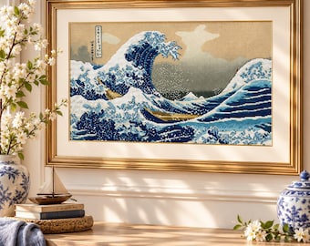 May include: A framed cross-stitch embroidery depicting a large, cresting blue wave with white foam, inspired by The Great Wave off Kanagawa. The artwork features a tan background, a small boat, and Japanese text in a vertical black rectangular box.
