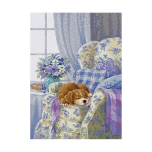 May include: A brown and white puppy dog is sleeping in a floral patterned armchair. The armchair has a purple throw blanket and is in a room with a window and a vase of flowers.