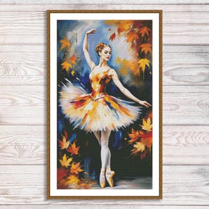 May include: A framed painting of a ballerina in a colorful tutu, set against a backdrop of autumn leaves. The artwork features a dancer in a graceful pose, with a palette of warm yellows, oranges, and blues.