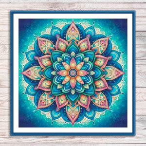 May include: A colourful mandala design with intricate details in shades of blue, green, pink, and yellow. The mandala is surrounded by a blue background with a subtle white pattern.