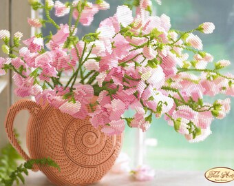 May include: A bouquet of pink sweet pea flowers in a peach-coloured ceramic jug with a textured surface. The flowers are arranged in a vase with a circular pattern.