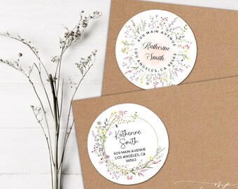 May include: Two round address labels with floral wreath designs. One label features the name "Katherine Smith" and address details. The other label has the same name and address. Both are on a brown envelope.