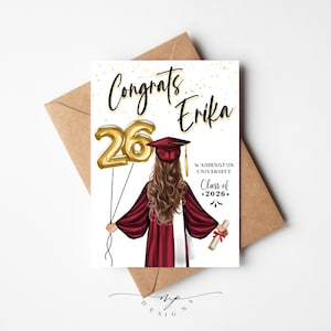 May include: A graduation card with the text "Congrats Erika" and gold foil number balloons. The illustration features a graduate in a maroon gown and cap, holding a diploma. The card also includes "Washington University Class of 2026."