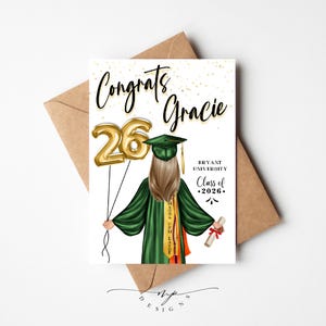 May include: A graduation card with the words "Congrats Gracie" in black script. The card features an illustration of a graduate in a green gown holding gold number 26 balloons. The card also includes the text "Bryant University Class of 2026."