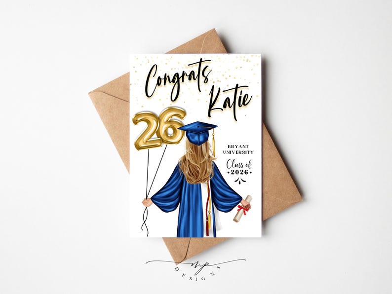 May include: A graduation card with the text "Congrats Katie" and "Class of 2026". The illustration shows a graduate in a blue gown holding gold number balloons. The card is on a brown envelope.