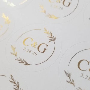 May include: Round white stickers with gold foil lettering. The stickers feature the initials "C&G" and the date "3.28.20".