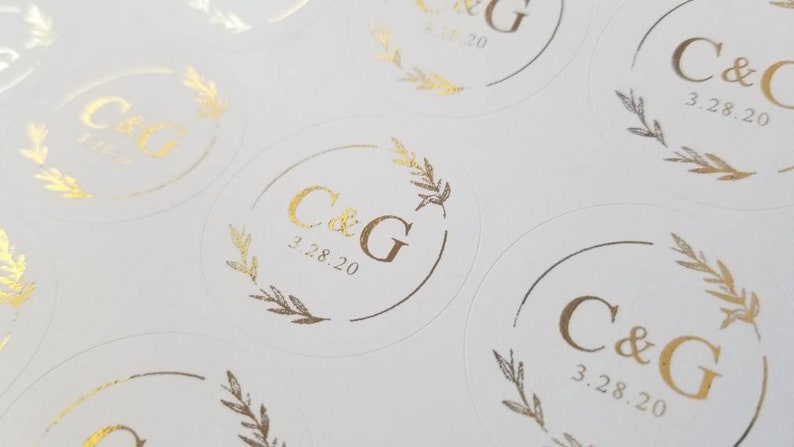 May include: Round white stickers with gold foil lettering. The stickers feature the initials "C&G" and the date "3.28.20".