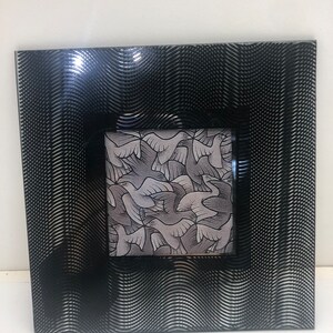 May include: Black picture frame with a wavy, textured design. The frame has a smaller, rectangular opening that shows a black and white image of birds.