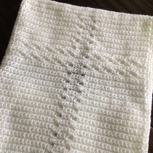 May include: White crocheted baby blanket with a diamond pattern.  Pink Pearl Crochet Boutique.