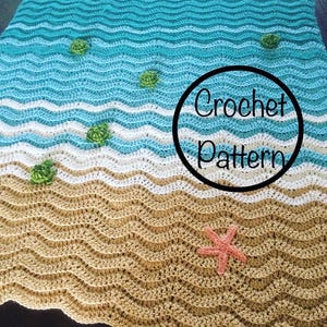 Op de afbeelding: Gehaakte deken met een strandthema. De deken heeft golvende patronen in blauw, wit en bruin, die op oceaangolven en zand lijken. Kleine groene schildpadapplicaties en een roze zeester zijn inbegrepen. De tekst "Crochet Pattern" staat in een zwarte cirkel.
