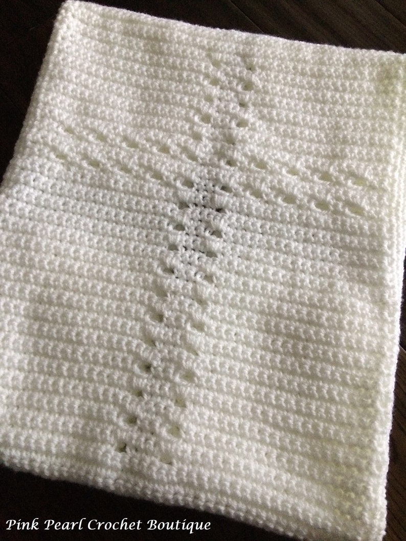 May include: White crocheted baby blanket with a diamond pattern.  Pink Pearl Crochet Boutique.