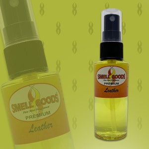 May include: Two bottles of yellow liquid with a black and red label that says "Smell Goods Pine Mist Fragrance Premium Leather".