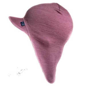 May include: A mauve-colored fleece hat with a long, pointed flap that covers the neck and ears. The hat has a short brim and a small label that says "BUFF"