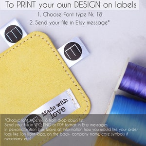 May include: A close-up of a yellow suede-like material with white labels. The labels have a black letter "E" inside a circle and the words "Made with love". Text at the top says "To PRINT your own DESIGN on labels".