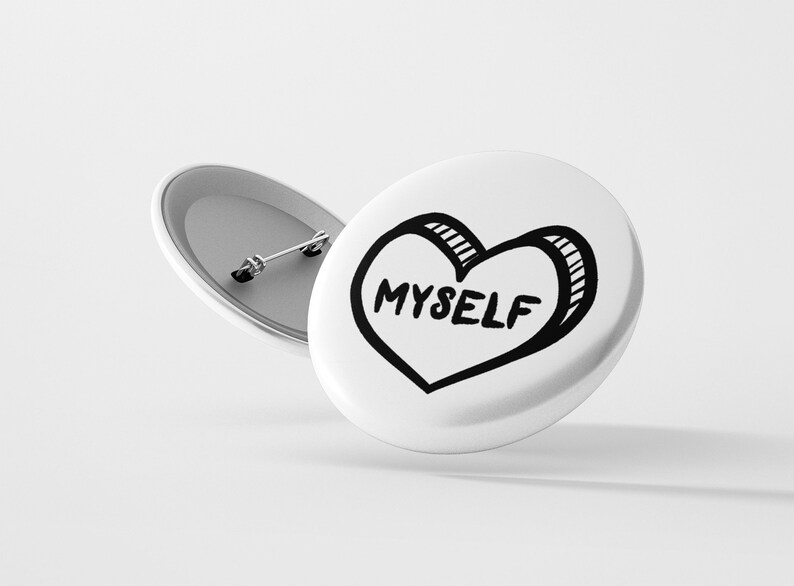 May include: White button with a black and white hand-drawn heart that says "MYSELF" on it.