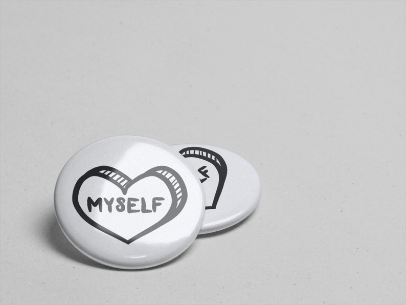 May include: Two white round buttons with black outlines. The button on the left has a black heart with the word "MYSELF" inside. The button on the right has a black design that resembles a stylized letter "S".