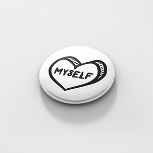 May include: White button with a black and white hand-drawn heart that says "MYSELF" inside.
