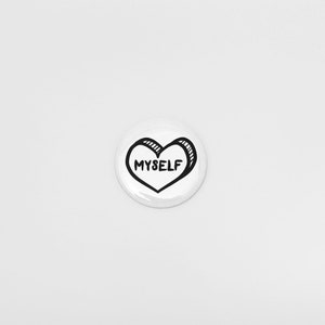 May include: White button with a black outline of a heart that says "MYSELF" inside.