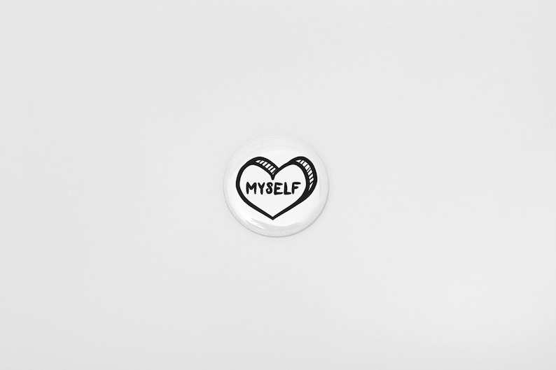 May include: White button with a black outline of a heart that says "MYSELF" inside.