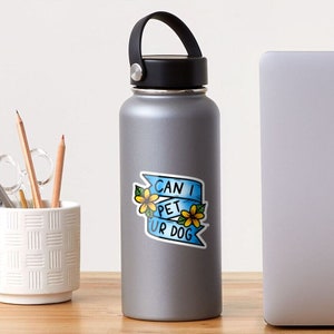 May include: A blue and white sticker with a banner that says "Can I Pet Ur Dog" with yellow flowers on either side.