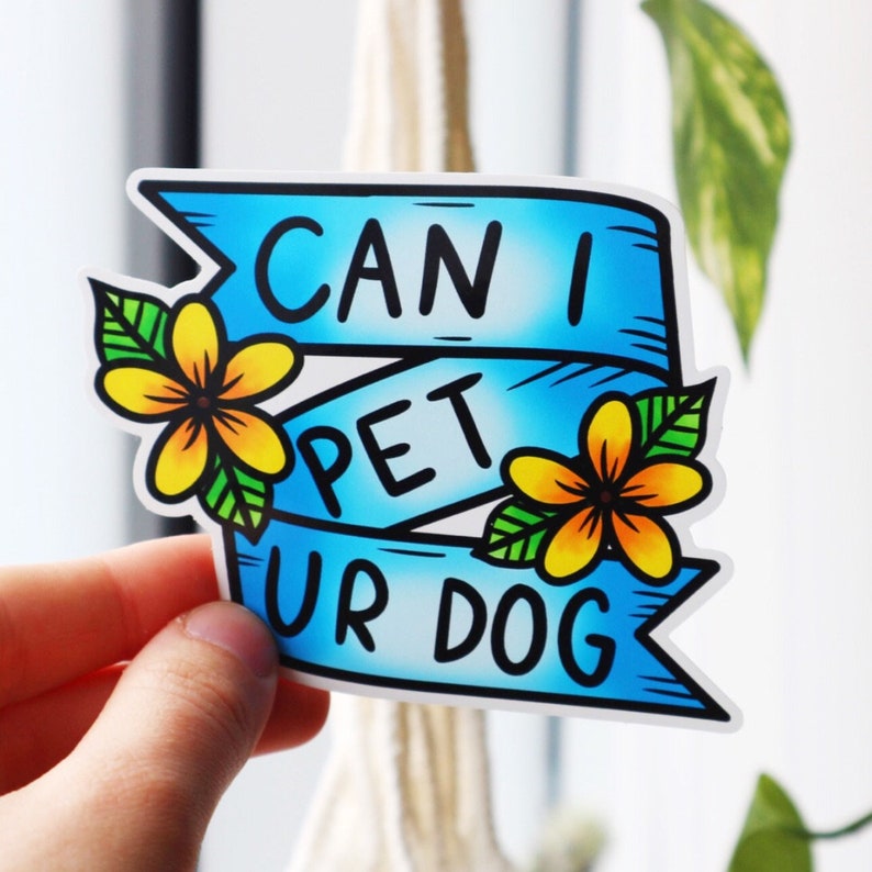 May include: Blue and white sticker with the text "Can I Pet Your Dog" in a banner style with yellow flowers on either side.