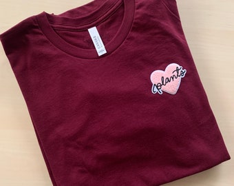 Maroon “Plants” in pink heart short sleeve t-shirt (unisex)