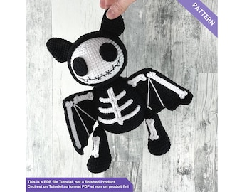 May include: A crocheted bat-shaped plush toy in black and white, featuring a skeleton design. The bat has large, round eyes and a stitched mouth. The image includes the text "PATTERN" and a disclaimer about the product being a PDF tutorial.