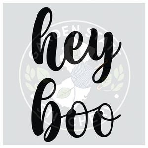 May include: A light gray graphic with the words "hey boo" in large, black, cursive lettering. A white ball of yarn is in the center of the graphic, with a light gray circle behind it.