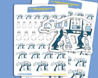 May include: A sheet of stickers featuring a cartoon illustration of an AT-AT walker from Star Wars. The stickers are white with blue and yellow accents. The text "ALL TERRAIN ARMORED TRANSPORT" is printed at the top of the sheet.