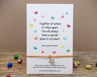 May include: A colorful card with a message about friendship and a star charm bracelet. The card reads "Together at school or miles apart. You will always have a special place in my heart. Have a great Summer!"  Make a wish as you place this bracelet on your wrist. When the cord wears through, your dreams may come true. www.thedreamingbuddha.com