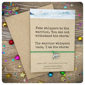 May include: A green string bracelet with a silver bear charm. The card attached to the bracelet reads "Fate whispers to the warrior, 'You can not withstand the storm.' The warrior whispers back, 'I am the storm.'"  Make a wish... as you place on your wrist. handmade in Lancashire England www.thedreamingbuddha.com