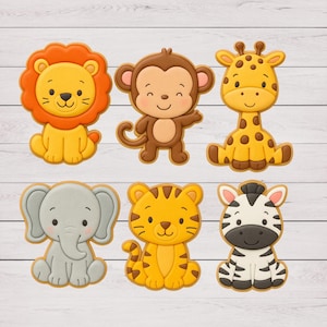 May include: Six animal-shaped cookies: a lion, monkey, giraffe, elephant, tiger, and zebra. The lion has an orange mane, the monkey is brown, and the giraffe has brown spots. The elephant is gray, the tiger is orange with brown stripes, and the zebra is black and white.