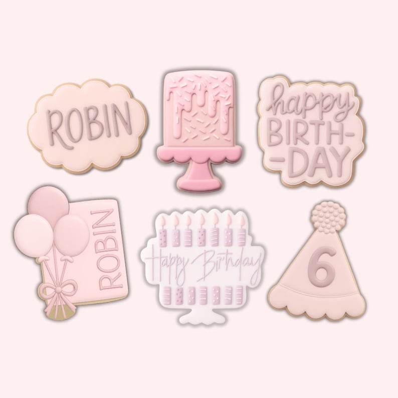 Pode incluir: Uma cole&ccedil;&atilde;o de biscoitos cor-de-rosa com tema de anivers&aacute;rio. Os biscoitos incluem formas como um bolo, bal&otilde;es, um chap&eacute;u de festa com o n&uacute;mero 6 e biscoitos com as palavras "ROBIN" e "Happy Birthday".