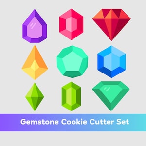 May include: A set of nine colorful gemstone-shaped cookie cutters in various geometric designs. The cutters are in shades of purple, red, orange, green, and blue. Text at the bottom reads "Gemstone Cookie Cutter Set."
